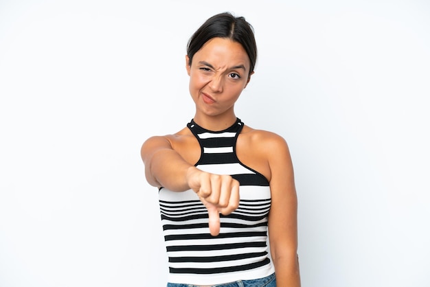 Photo young hispanic woman isolated on white background showing thumb down with negative expression