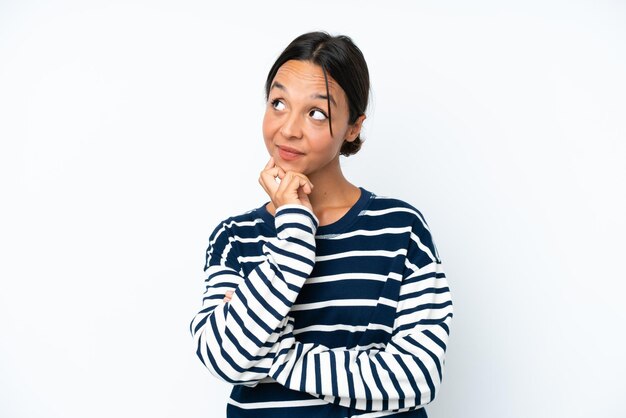 Young hispanic woman isolated on white background thinking an idea while looking up