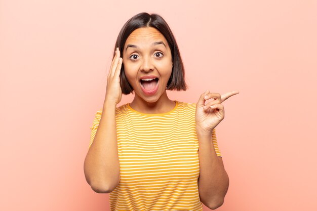 Young hispanic woman laughing