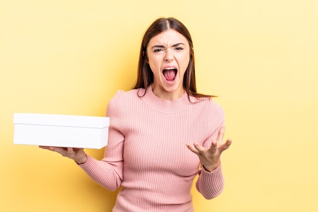 Young hispanic woman looking angry, annoyed and frustrated. empty box concept