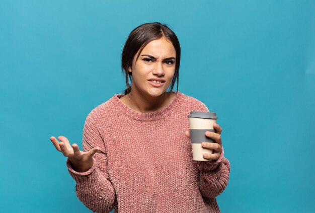 Young hispanic woman looking angry, annoyed and frustrated screaming wtf or whatâs wrong with you