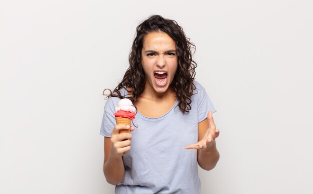 Young hispanic woman looking angry, annoyed and frustrated screaming wtf