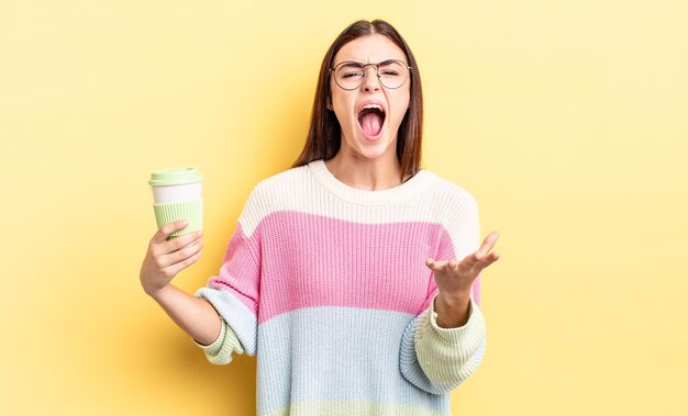 Young hispanic woman looking angry, annoyed and frustrated. take away coffee concept