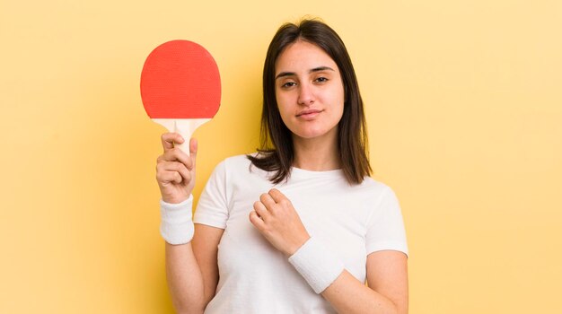 Young hispanic woman looking arrogant successful positive and proud ping pong concept