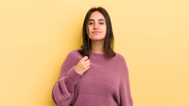 Young hispanic woman looking arrogant successful positive and proud pointing to self