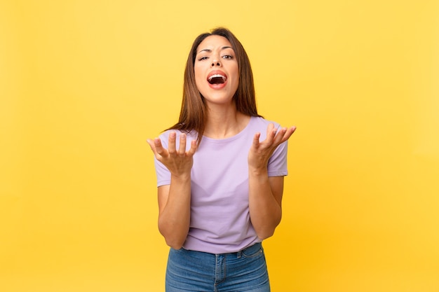 Young hispanic woman looking desperate, frustrated and stressed