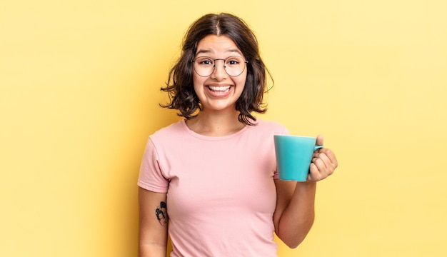 Young hispanic woman looking happy and pleasantly surprised. coffee mug concept