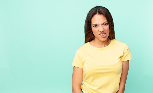 Young hispanic woman looking puzzled and confused