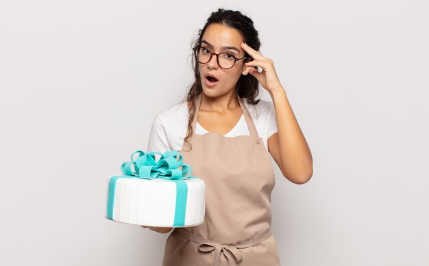 Young hispanic woman looking surprised, open-mouthed, shocked, realizing a new thought, idea or concept