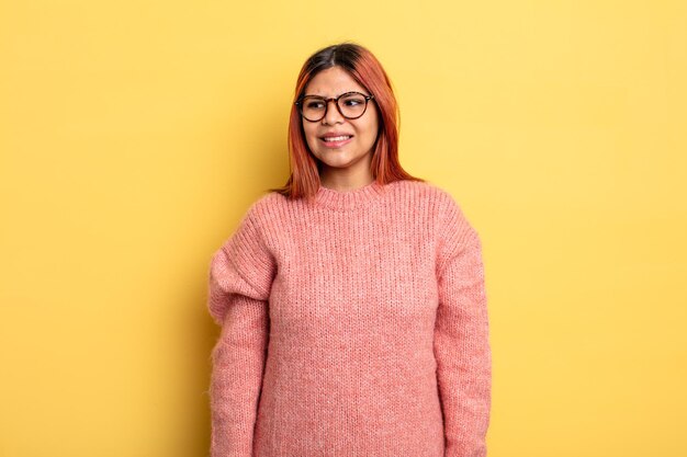 young hispanic woman looking worried, stressed, anxious and scared, panicking and clenching teeth