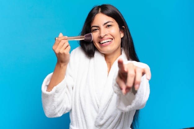 Young hispanic woman making up