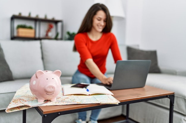 Young hispanic woman organizing trip at home