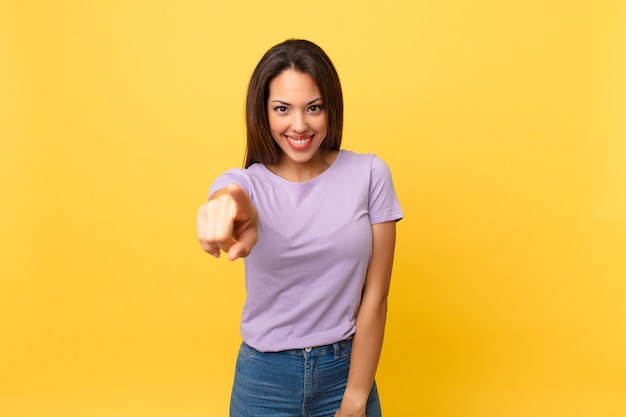 Young hispanic woman pointing at camera choosing you