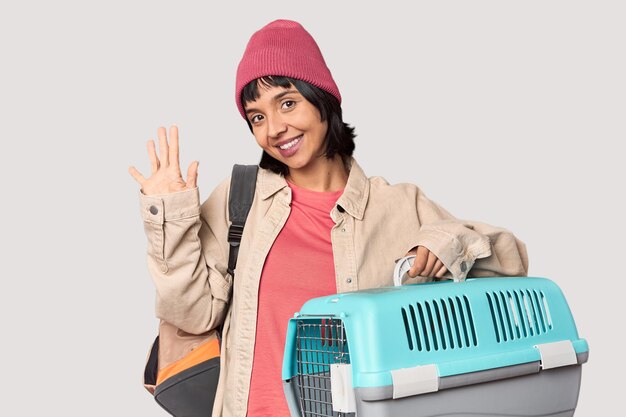 Young Hispanic woman ready for travel with pet carrier showing a disappointment gesture