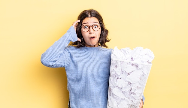 Young hispanic woman screaming with hands up in the air fail trash concept