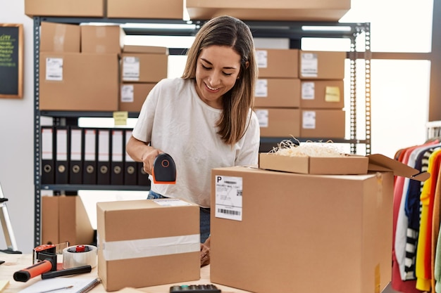 Young hispanic woman smiling confident working at store