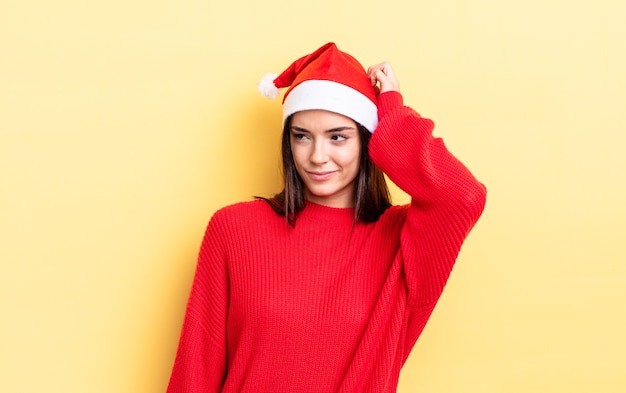 Young hispanic woman smiling happily and daydreaming or doubting. chistmas and new year concept