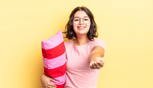 Young hispanic woman smiling happily with friendly and  offering and showing a concept. morning wake up concept