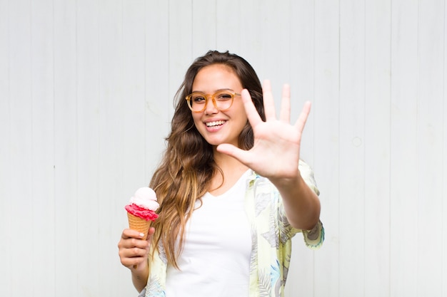 Young hispanic woman smiling and looking friendly