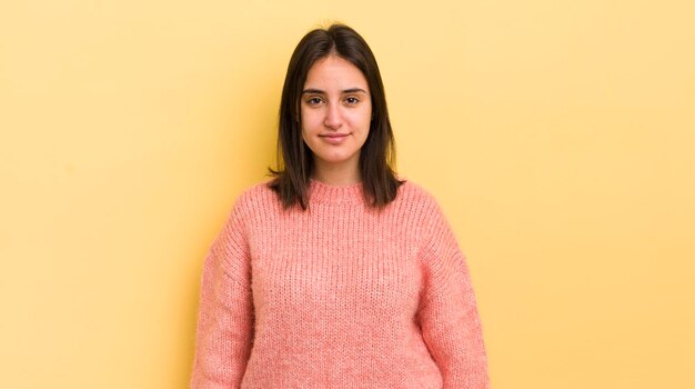 Young hispanic woman smiling positively and confidently looking satisfied friendly and happy