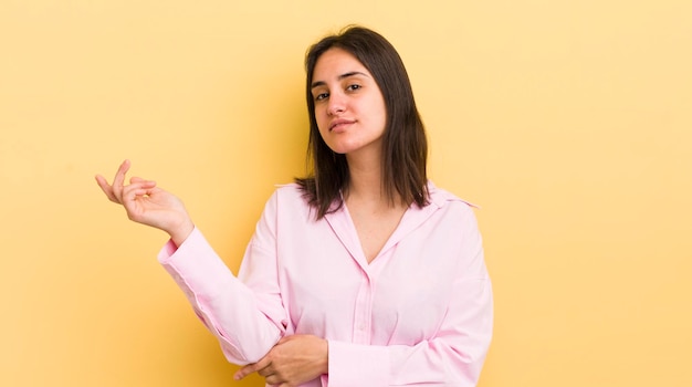 Young hispanic woman smiling proudly and confidently feeling happy and satisfied and showing a concept on copy space