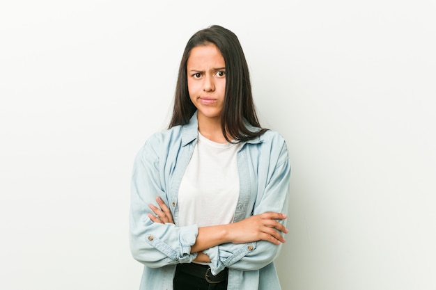 Young hispanic woman unhappy looking with sarcastic expression.