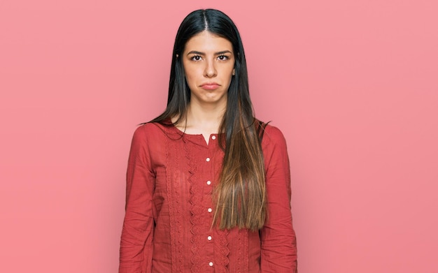 Young hispanic woman wearing casual clothes depressed and worry for distress crying angry and afraid sad expression