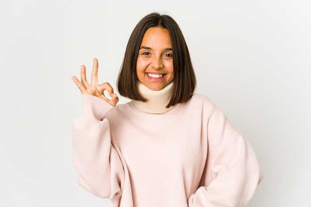 Young hispanic woman wearing a collar cheerful and confident showing ok gesture.