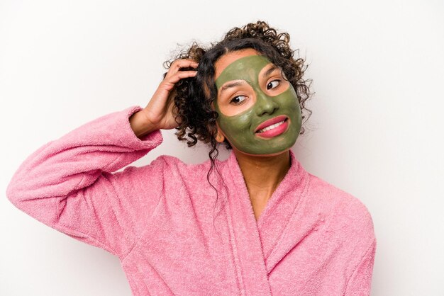 Young hispanic woman wearing a facial mask isolated on white background