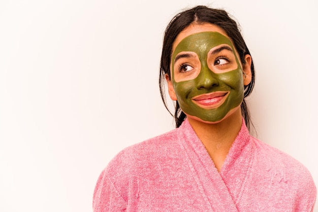 Young hispanic woman wearing facial mask isolated on white background