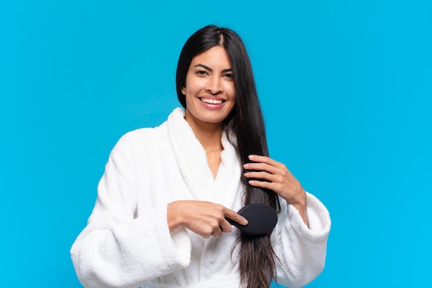 Young hispanic woman with a hair brush.