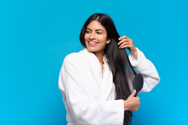 Young hispanic woman with a hair brush