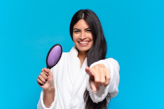 Young hispanic woman with a hair brush