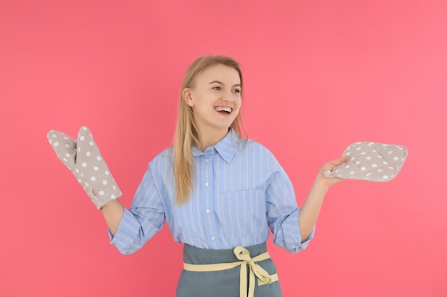 Young housewife or chef on pink background