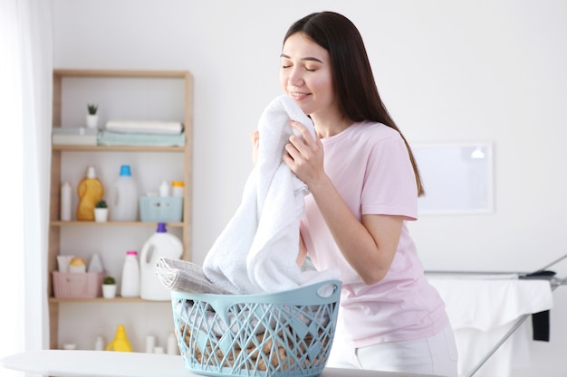 Young housewife in the laundry room closeup