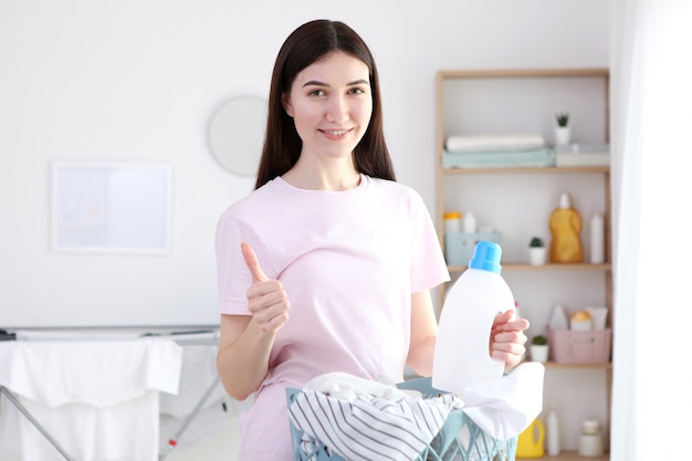 Young housewife in the laundry room closeup