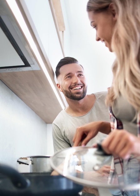 Young husband and wife cook dinner together