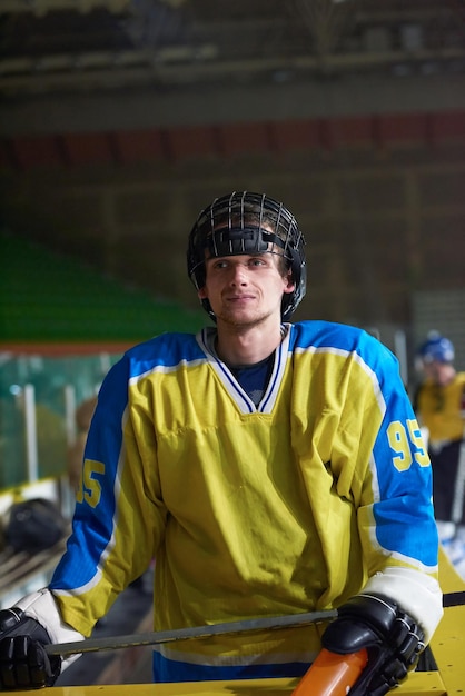 young ice hockey player portrait on training in black background