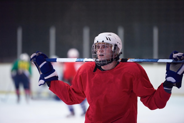 young ice hockey player portrait on training in black background