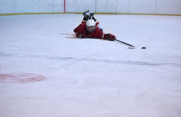 young ice hockey player portrait on training in black background