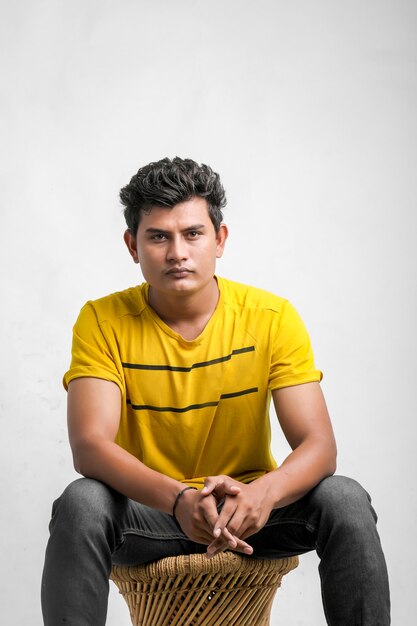 Young indian boy showing expression over white background.