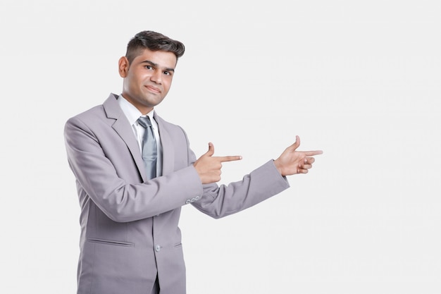 Young indian business man showing direction with hand