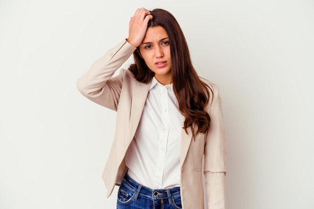 Young Indian business woman isolated on white being shocked, she has remembered important meeting.