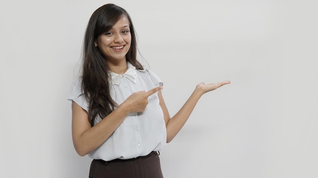 Young Indian business woman pointing with the index finger a great idea on grey background