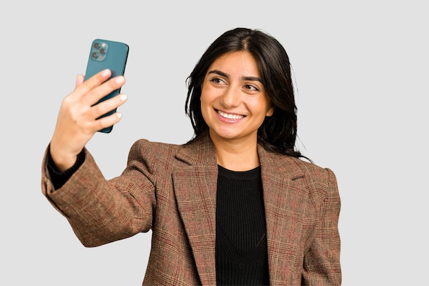 Young indian business woman taking herself a selfie with a mobile phone