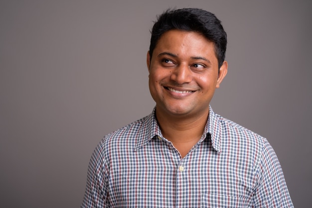 young Indian businessman wearing checkered shirt 