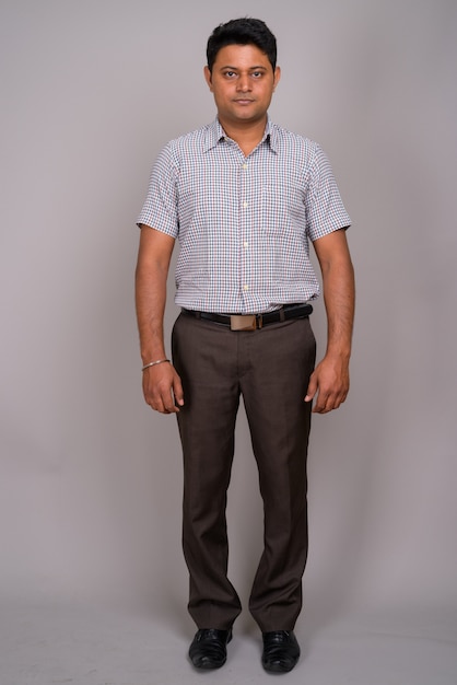 young Indian businessman wearing checkered shirt 