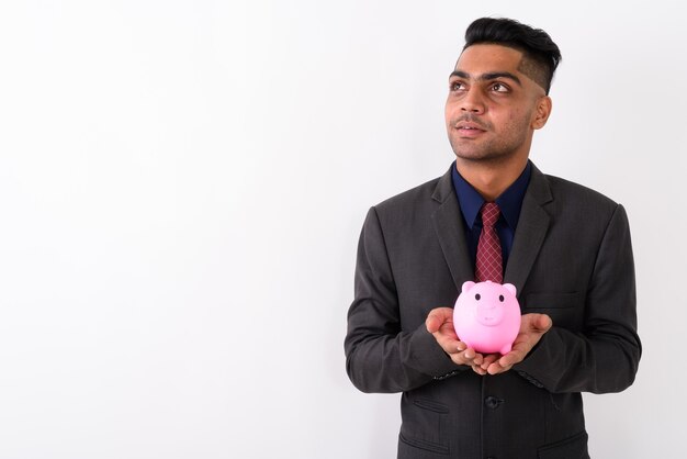 Young Indian businessman wearing suit on white