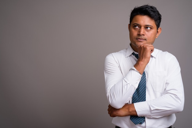 young Indian businessman wearing white shirt and tie 