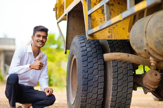 Young indian businessman with his freight forward lorry or truck.